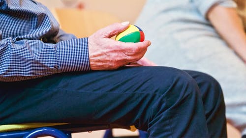 man holding a colourful ball