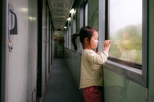 child looking though the window