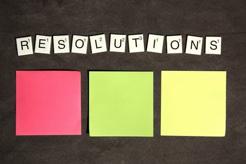 scrabble letters spelling resolutions and post it notes