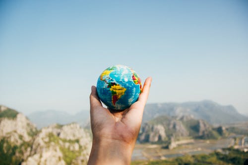 holding a world globe