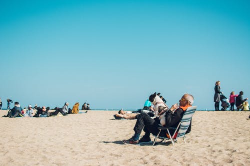 man and dog hanging out on the beach
