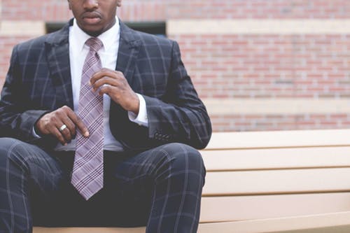 man grabbing his tie