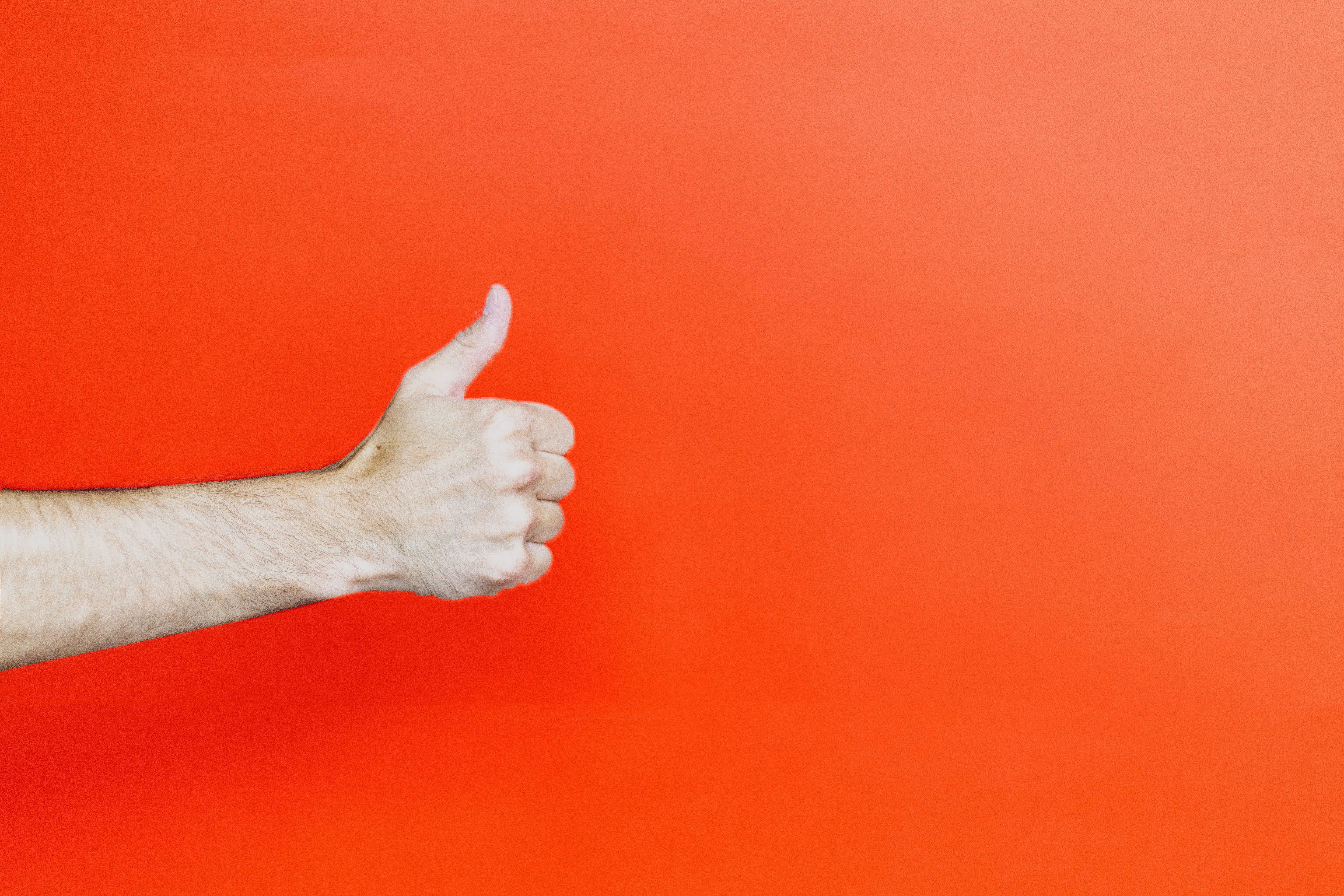 thumbs up on red background